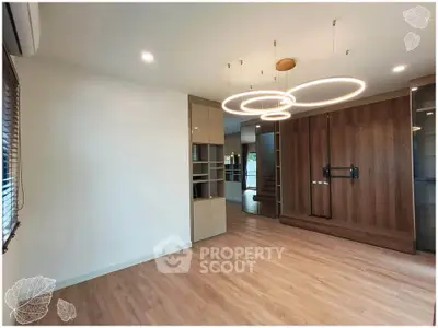 Spacious modern living room with elegant lighting and wooden flooring