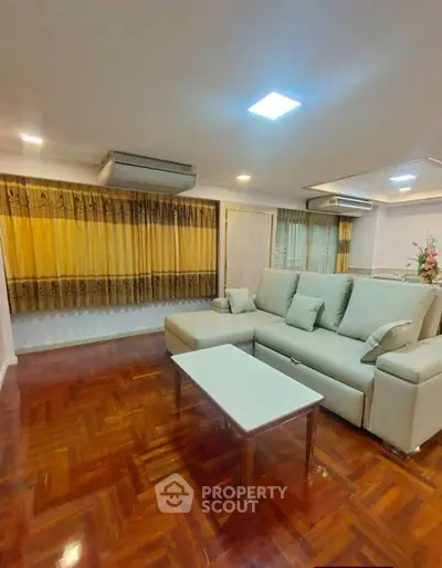 Spacious living room with elegant parquet flooring and modern furniture