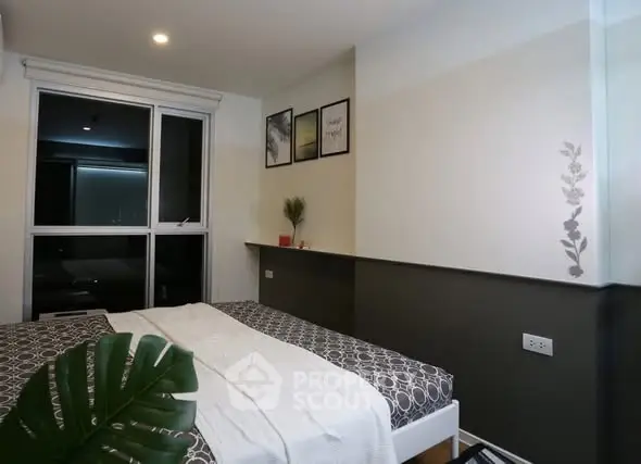 Modern bedroom with stylish decor and large window for natural light