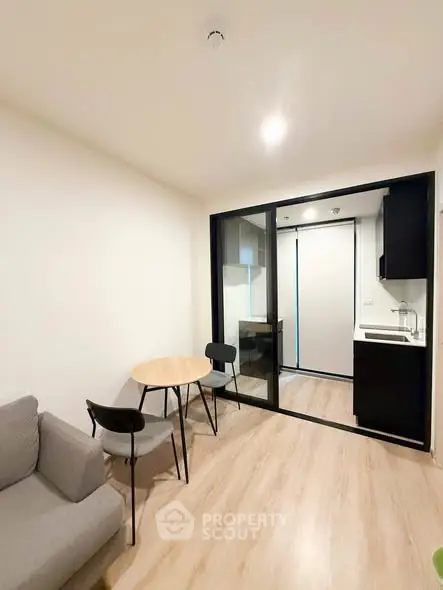 Modern apartment interior with cozy living area and compact kitchen