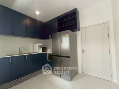 Modern kitchen with sleek cabinets and stainless steel fridge