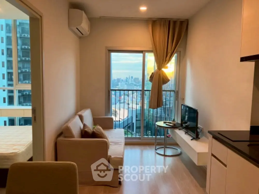 Cozy living room with city view and modern furnishings in a high-rise apartment.