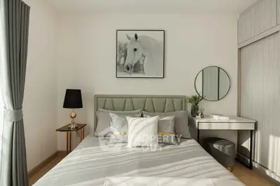 Modern bedroom with stylish decor and natural light, featuring a cozy bed and elegant furnishings.