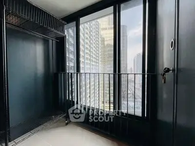 Modern urban apartment with floor-to-ceiling windows offering stunning city views.