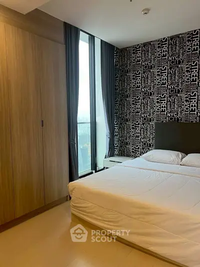 Modern bedroom with city-themed wallpaper and large window view