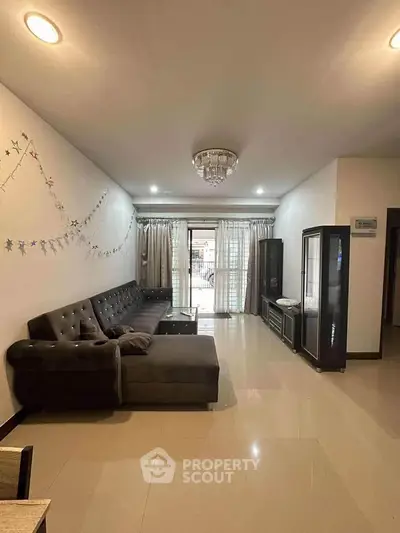 Spacious living room with elegant decor and large windows for natural light.