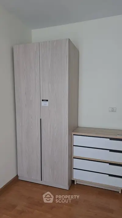 Modern bedroom with sleek wardrobe and dresser, perfect for stylish storage solutions.