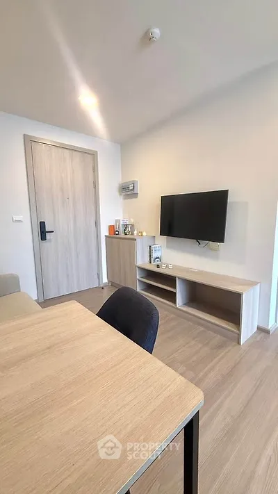 Modern living room with sleek wooden furniture and wall-mounted TV
