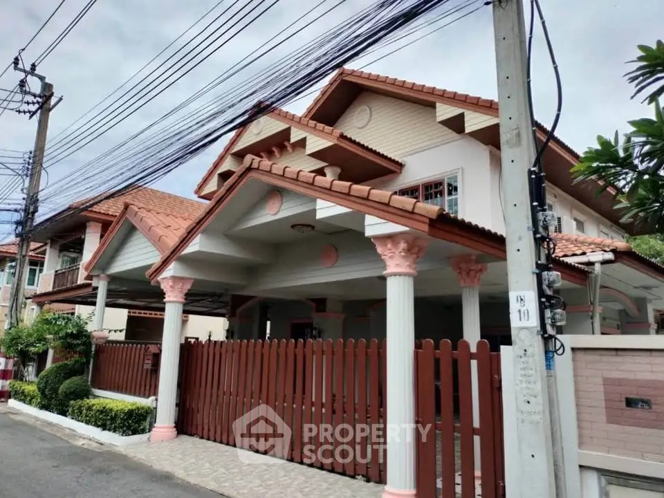 Charming suburban house with unique architectural design and spacious front yard, perfect for family living.