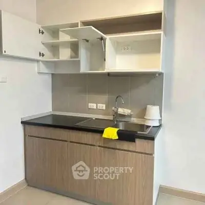 Modern kitchen with open cabinets and sleek design in a contemporary apartment.