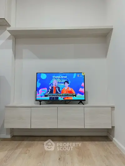 Modern living room with sleek TV unit and wooden flooring