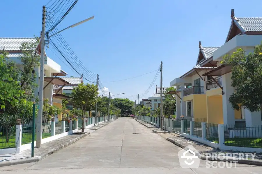 Charming suburban street with modern houses and lush greenery, perfect for family living.