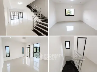 Spacious modern home interior with sleek staircase and large windows for natural light.