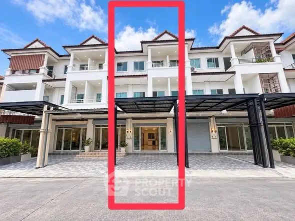 Elegant multi-story townhouse with modern facade and spacious balconies in a serene neighborhood.