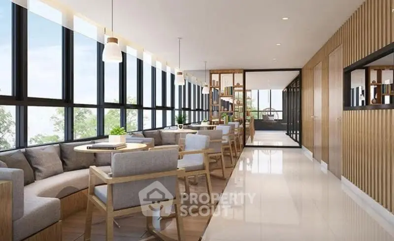 Modern and spacious living area with large windows and stylish furniture