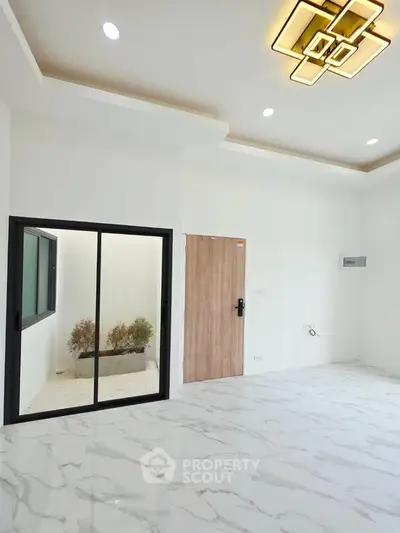 Spacious modern living room with elegant lighting and marble flooring