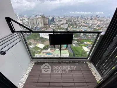 Stunning city view from a modern balcony with sleek railing and wooden flooring.