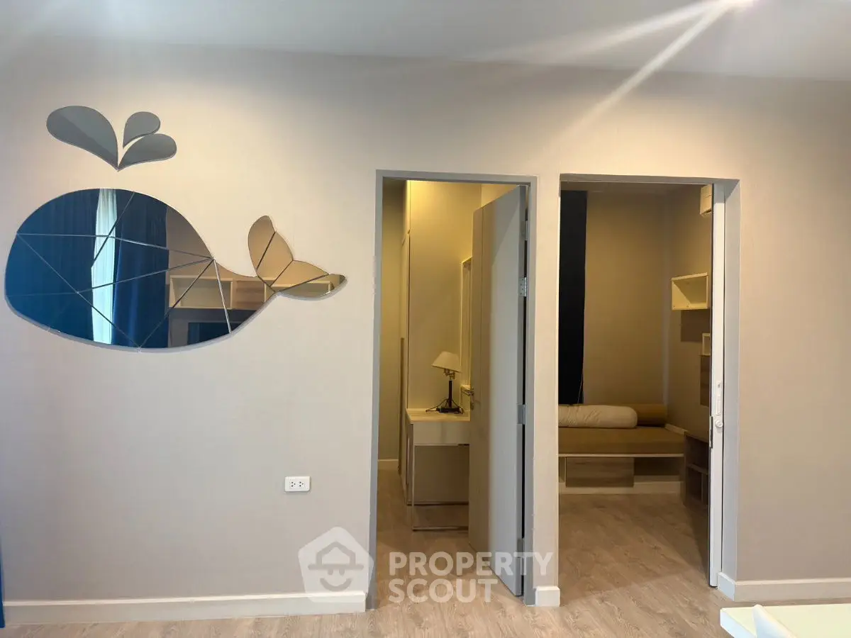 Modern apartment interior with unique wall mirror and cozy bedroom view.