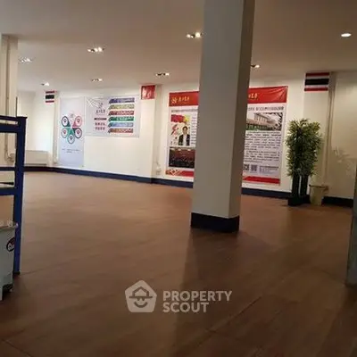 Spacious interior with modern flooring and informational banners, ideal for commercial use.