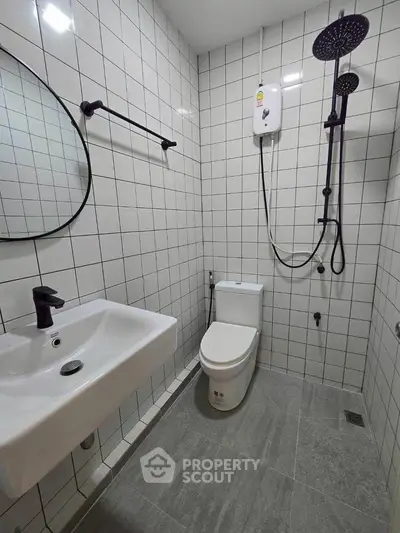 Modern bathroom with sleek fixtures and tiled walls
