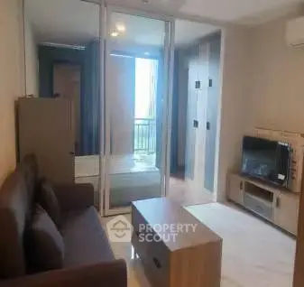 Modern living room with glass partition and cozy furniture in a stylish apartment.