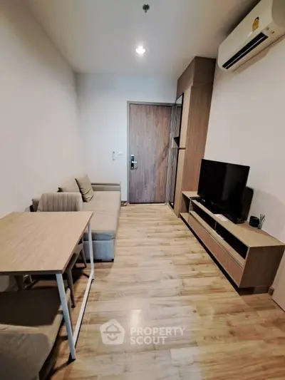 Modern living room with wooden flooring and sleek furniture design