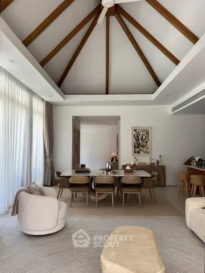 Luxurious living room with vaulted ceiling and elegant dining area