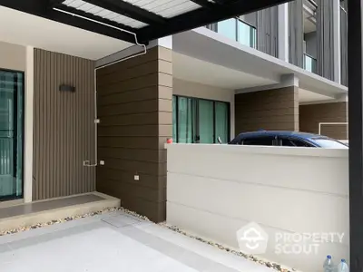 Modern townhouse exterior with carport and sleek design