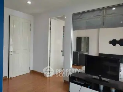 Modern living room with sleek TV stand and wooden flooring in a contemporary apartment.