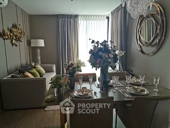 Elegant living and dining area with modern decor and natural light