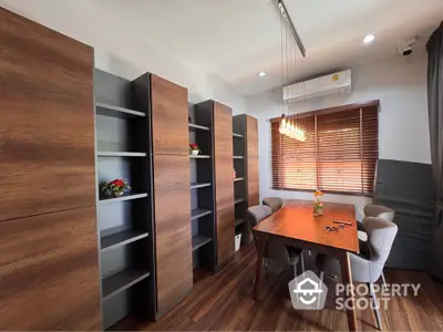 Modern study room with wooden shelves and elegant lighting