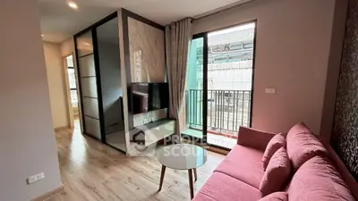 Modern living room with pink sofa and balcony view in stylish apartment.