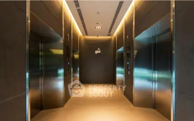 Modern elevator lobby with sleek design and ambient lighting