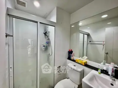 Modern bathroom with glass shower and sleek fixtures in a contemporary home.