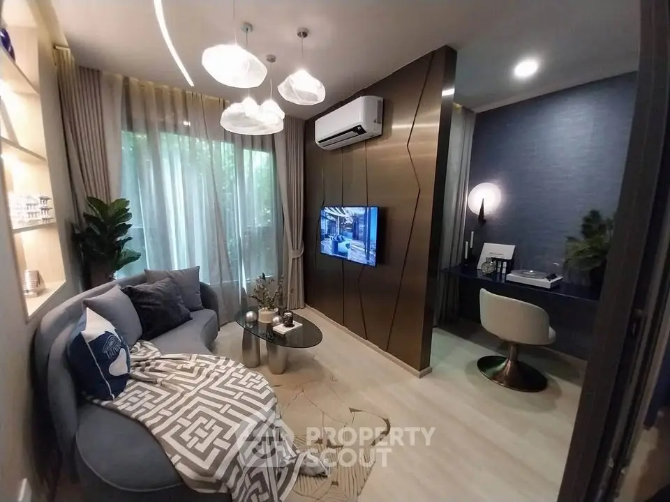 Modern living room with stylish decor and adjacent study area, featuring elegant lighting and contemporary furnishings.