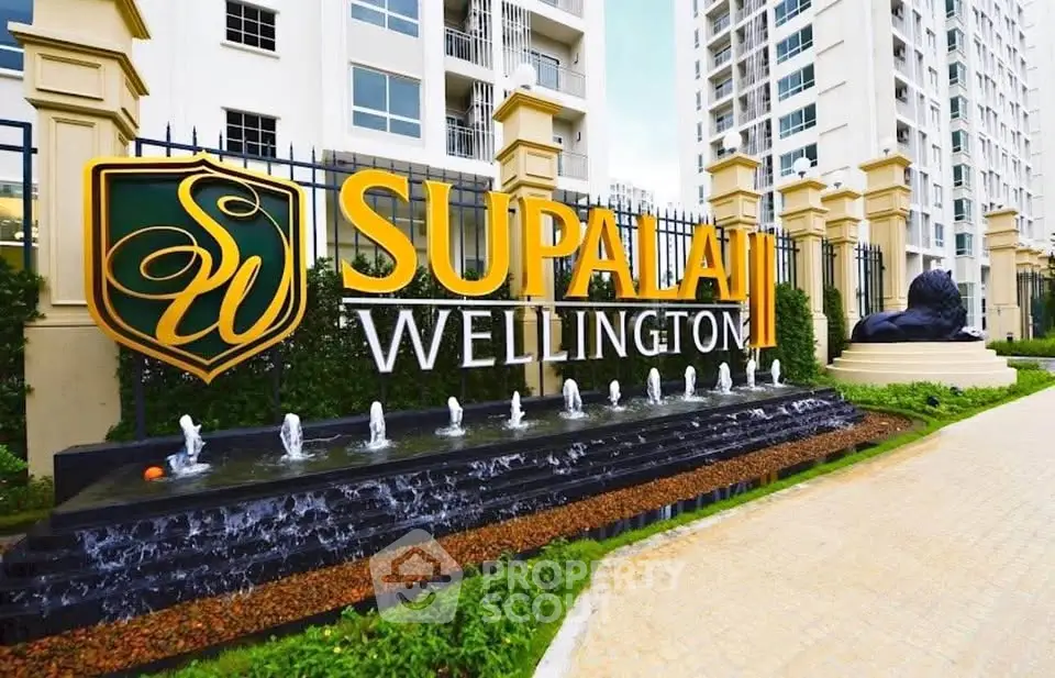 Elegant entrance of Supalai Wellington with modern architecture and water feature.