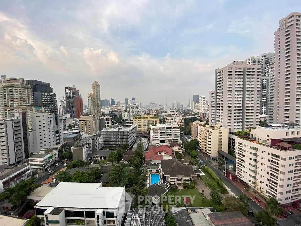 Stunning cityscape view with high-rise buildings and a pool in the foreground.
