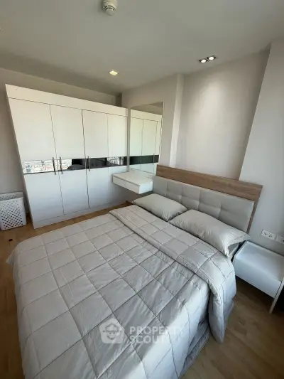 Modern bedroom with sleek wardrobe and cozy bed in a high-rise apartment