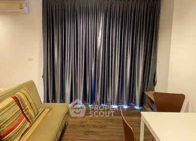 Cozy living room with stylish curtains and modern furniture, perfect for relaxation and comfort.