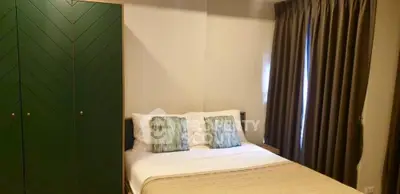 Cozy bedroom with stylish green wardrobe and elegant curtains