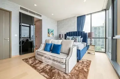 Luxurious modern bedroom with floor-to-ceiling windows and elegant decor in high-rise apartment.