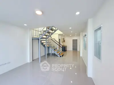 Spacious modern living room with sleek staircase and open layout