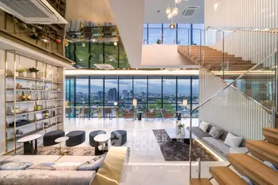 Luxurious modern living room with panoramic city views and elegant staircase
