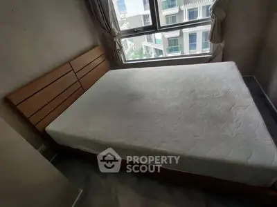 Cozy bedroom with large window and modern bed frame