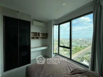 Modern bedroom with panoramic city view and large windows