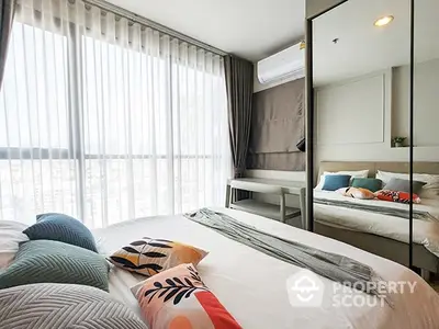 Bright and airy bedroom with large windows offering ample natural light, modern furnishings, and a cozy, welcoming ambiance perfect for relaxation.