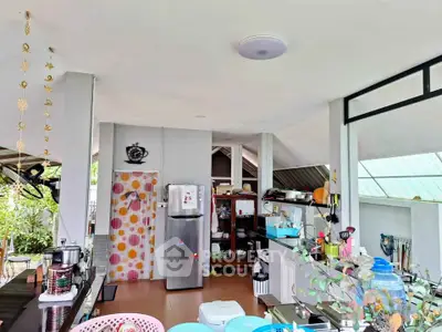 Spacious open-layout kitchen with modern appliances and ample natural light, perfect for culinary enthusiasts.