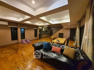 Spacious living room with modern decor and wooden flooring