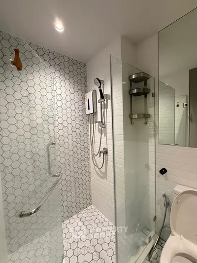 Modern bathroom with glass shower enclosure and stylish tile design