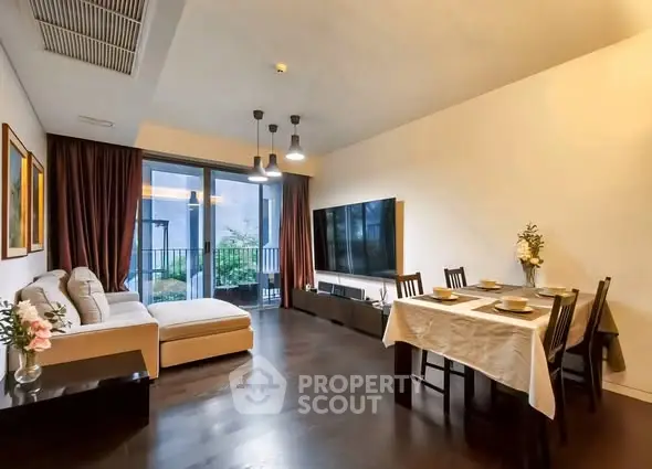 Spacious modern living room with elegant dining area and balcony access